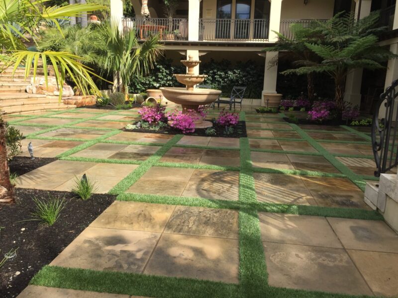 landscaping with stonework, water feature, plants